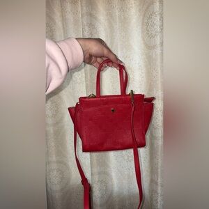 Red Steve Madden crossbody hand bag with gold accents